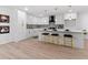 Modern white kitchen with gold accents, island, and quartz countertops at 4399 Plantation Ln, Norcross, GA 30093