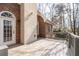 Back deck of brick house with a whitewashed chimney and view of surrounding trees at 8240 Knollbrook Ln, Mcdonough, GA 30253