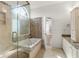 Bright bathroom featuring a soaking tub with mosaic tile and a granite countertop vanity at 8240 Knollbrook Ln, Mcdonough, GA 30253