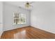 This bedroom features hardwood floors and a large window at 8240 Knollbrook Ln, Mcdonough, GA 30253