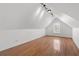 Bright upstairs bonus room featuring hardwood floors and natural light from the window at 8240 Knollbrook Ln, Mcdonough, GA 30253