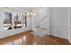 Bright dining room featuring hardwood floors, large windows, and an elegant chandelier at 8240 Knollbrook Ln, Mcdonough, GA 30253