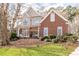 Charming two-story home featuring brick and stucco exterior with a welcoming front porch and well-maintained landscaping at 8240 Knollbrook Ln, Mcdonough, GA 30253