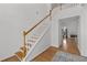 Elegant foyer with hardwood floors, staircase with wooden railing, and a view into the living room, offering a warm welcome at 8240 Knollbrook Ln, Mcdonough, GA 30253