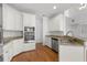 Well-equipped kitchen featuring white cabinets, granite countertops, and modern stainless steel appliances at 8240 Knollbrook Ln, Mcdonough, GA 30253