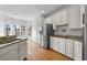 Open kitchen featuring white cabinets, granite countertops, and stainless steel refrigerator at 8240 Knollbrook Ln, Mcdonough, GA 30253