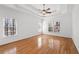 This main bedroom features hardwood floors, tray ceiling and large windows at 8240 Knollbrook Ln, Mcdonough, GA 30253