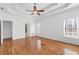 This main bedroom features hardwood floors, tray ceiling and large windows at 8240 Knollbrook Ln, Mcdonough, GA 30253