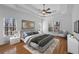 Stylishly staged main bedroom with hardwood floors and large windows at 8240 Knollbrook Ln, Mcdonough, GA 30253