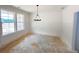 A bright dining room with large windows and modern chandelier, ready for personalization at 1257 Pj East Rd, Covington, GA 30014