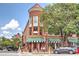 Charming red brick building with black and white awnings, red roof, and American flags adding to the street appeal at 1257 Pj East Rd, Covington, GA 30014