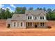 Two story home featuring a gray exterior, white trim, and a covered front porch on a spacious lot at 1257 Pj East Rd, Covington, GA 30014