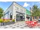 Exterior of City Pharmacy, featuring its classic white brick facade, outdoor seating, and street view at 1257 Pj East Rd, Covington, GA 30014