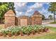 A brick sign marks the entrance to Monroe Golf and Country Club, enhanced with colorful flowers at 1257 Pj East Rd, Covington, GA 30014