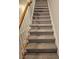 Carpeted stairs with wooden railing at 4221 Sw Notting Hill Sw Dr, Atlanta, GA 30331