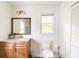 Bright bathroom with wood vanity and large mirror at 673 Windsor Sw St, Atlanta, GA 30310