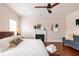 Bright bedroom with a king-size bed, fireplace, and hardwood floors at 673 Windsor Sw St, Atlanta, GA 30310