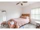 Cozy bedroom with blush bedding and a full-length mirror at 673 Windsor Sw St, Atlanta, GA 30310