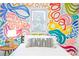 Bedroom with colorful mural and bohemian-style bedding at 673 Windsor Sw St, Atlanta, GA 30310