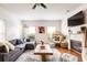 Spacious living room with hardwood floors, sectional sofa, fireplace and large TV at 673 Windsor Sw St, Atlanta, GA 30310