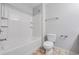 A bright bathroom features a white tub with shower and a low-flow white toilet at 2166 Waterford Park Dr, Lawrenceville, GA 30044