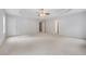 Large bedroom featuring tray ceilings, neutral walls, carpet, and multiple doors at 2166 Waterford Park Dr, Lawrenceville, GA 30044