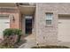 Welcoming front entrance with a black door and a charming brick facade at 2166 Waterford Park Dr, Lawrenceville, GA 30044