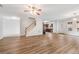 Spacious open-concept living room with hardwood floors, staircase, and view into the kitchen at 2166 Waterford Park Dr, Lawrenceville, GA 30044