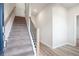 Staircase with carpeted steps and dark metal railing at 258 Wilder Ridge Way, Lawrenceville, GA 30044