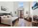 Bright bedroom featuring hardwood floors and a fireplace at 3505 Moss Landing Rd, Acworth, GA 30102