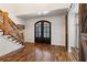 Two-story entry with hardwood floors, barn doors, and a wooden staircase at 3505 Moss Landing Rd, Acworth, GA 30102
