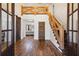 Grand entryway with rustic wooden floors, staircase, and barn door at 3505 Moss Landing Rd, Acworth, GA 30102