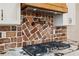 Close-up of herringbone brick backsplash and gas cooktop at 3505 Moss Landing Rd, Acworth, GA 30102