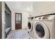Laundry room with washer, dryer, and brick flooring at 3505 Moss Landing Rd, Acworth, GA 30102