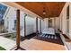 Charming porch with a wooden swing and black and white checkered rug at 3505 Moss Landing Rd, Acworth, GA 30102