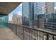 Spacious balcony with glass railings and a beautiful view of the city's modern architecture and street below at 1080 Peachtree Ne St # 804, Atlanta, GA 30309