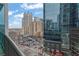 Scenic view from a balcony overlooking city buildings and street with parked cars on a clear day at 1080 Peachtree Ne St # 804, Atlanta, GA 30309