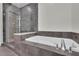 Luxurious bathroom features a soaking tub with tile surround and a glass-enclosed shower for ultimate relaxation at 1080 Peachtree Ne St # 804, Atlanta, GA 30309