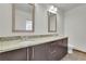 Bathroom features double sinks with a granite countertop, dark cabinets, and modern fixtures at 1080 Peachtree Ne St # 804, Atlanta, GA 30309