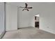 Bright bedroom with neutral carpet, ceiling fan and a view of the kitchen through the doorway at 1080 Peachtree Ne St # 804, Atlanta, GA 30309