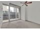 Spacious carpeted bedroom featuring sliding glass doors leading to a balcony and a ceiling fan at 1080 Peachtree Ne St # 804, Atlanta, GA 30309