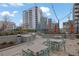 Outdoor grill area with dining tables, chairs, and views of the surrounding buildings at 1080 Peachtree Ne St # 804, Atlanta, GA 30309