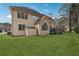 Expansive backyard featuring a well-maintained lawn, a patio area, and lush greenery, perfect for outdoor activities at 2035 Walnut Creek Xing, Alpharetta, GA 30005