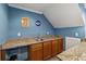 Basement wet bar with granite countertop and wood cabinets at 2035 Walnut Creek Xing, Alpharetta, GA 30005