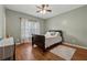 Bright bedroom with hardwood floors, a ceiling fan, and plenty of natural light at 2035 Walnut Creek Xing, Alpharetta, GA 30005