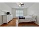 Bright bedroom with hardwood floors, a ceiling fan, and neutral decor at 2035 Walnut Creek Xing, Alpharetta, GA 30005