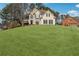 Two-story house with a large front yard and a basketball court at 2035 Walnut Creek Xing, Alpharetta, GA 30005