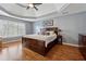 Main bedroom with hardwood floors and tray ceiling at 2035 Walnut Creek Xing, Alpharetta, GA 30005