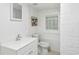 Basement bathroom with a toilet, sink, and a window at 261 Fletcher Sw St, Atlanta, GA 30315