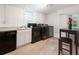 Basement kitchen features white cabinets, black appliances, and a small table at 261 Fletcher Sw St, Atlanta, GA 30315